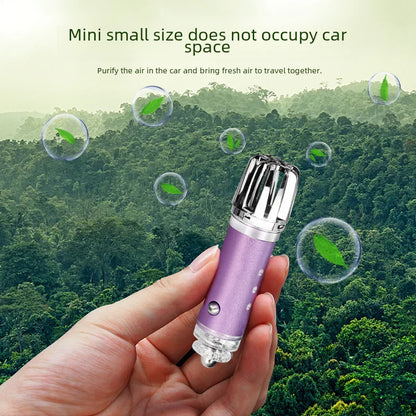 Hand holding compact car air purifier with forest background and floating leaves, eco-friendly gadget
